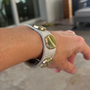 Bracelet, silver white imitation leather and gold tone.